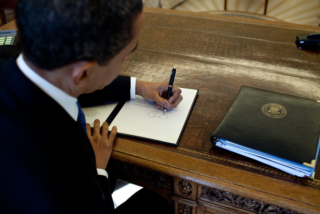 File:Barack Obama signs.jpg