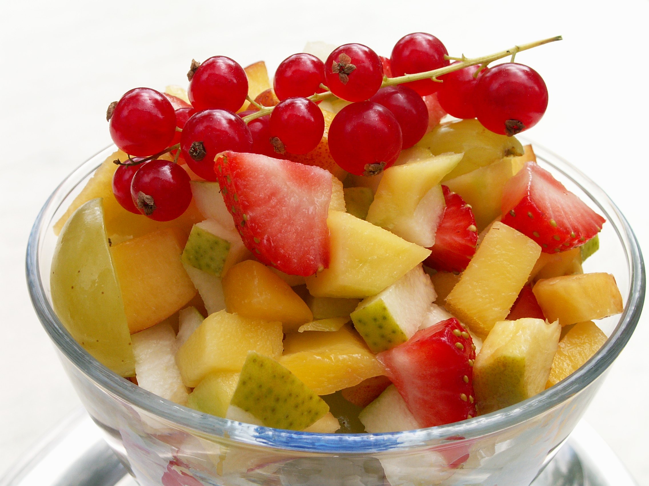 On the picture you can see a cup. In the cup are different types of fruit. The fruit is cut into small pieces. That is fruit salad.