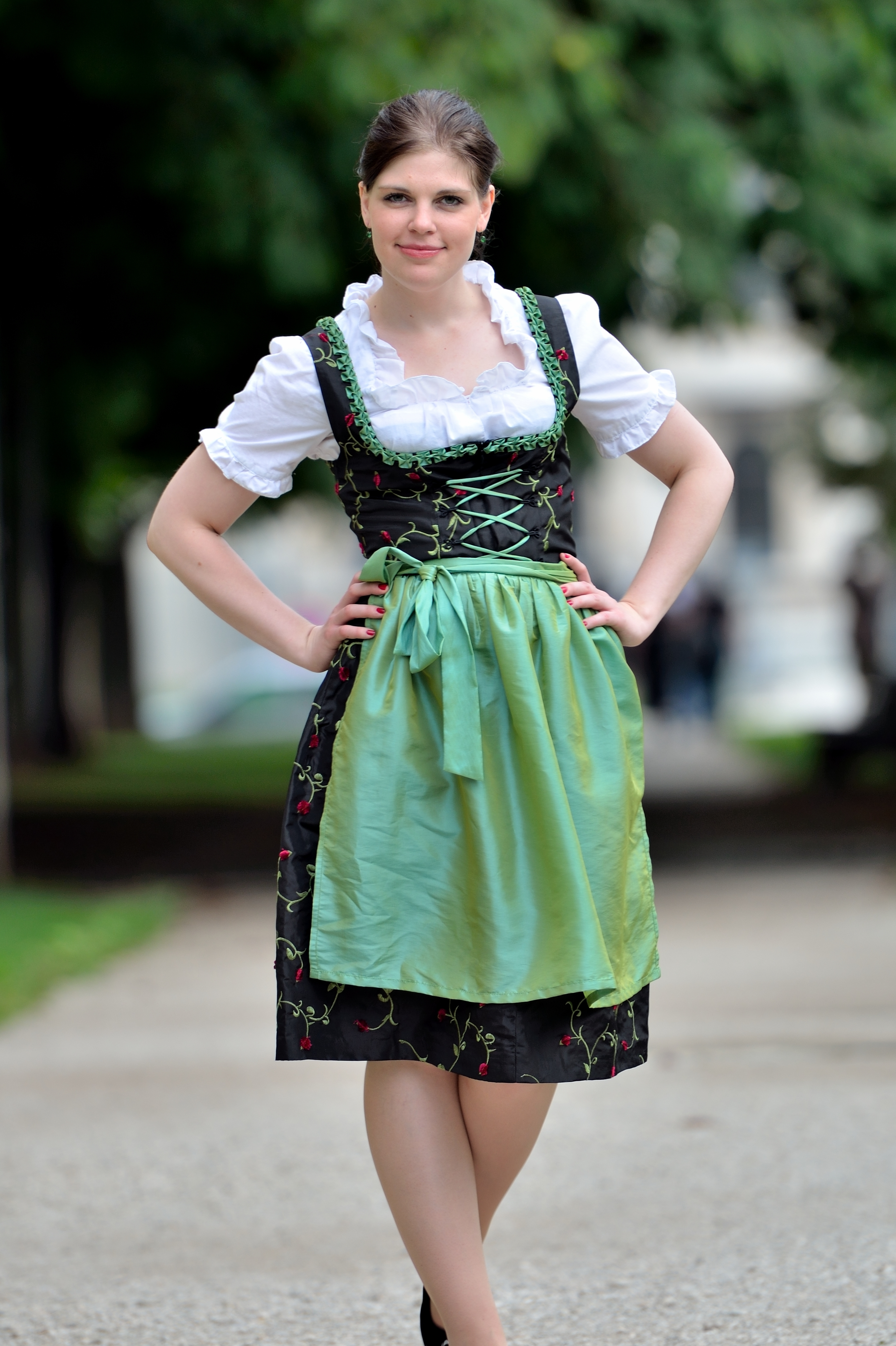On the picture is a woman. The woman is wearing a Dirndl Dress with apron and Dirndl blouse.